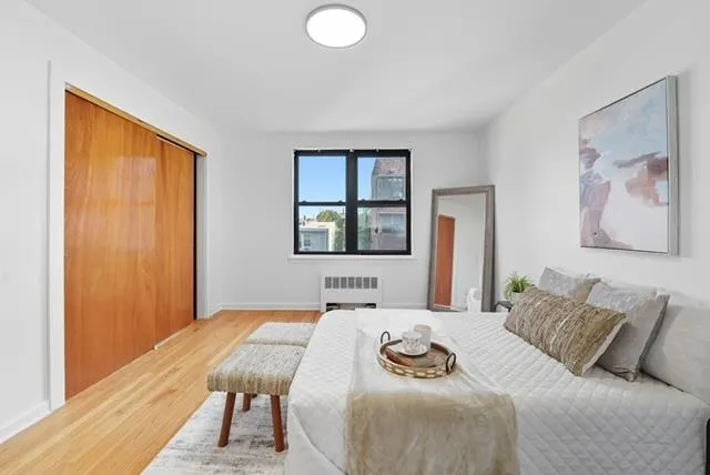 a bedroom with a large bed and a window