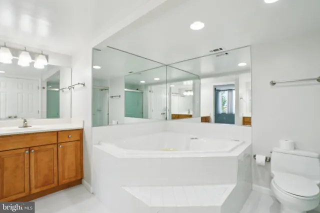 a white bath tub sitting next to a white toilet