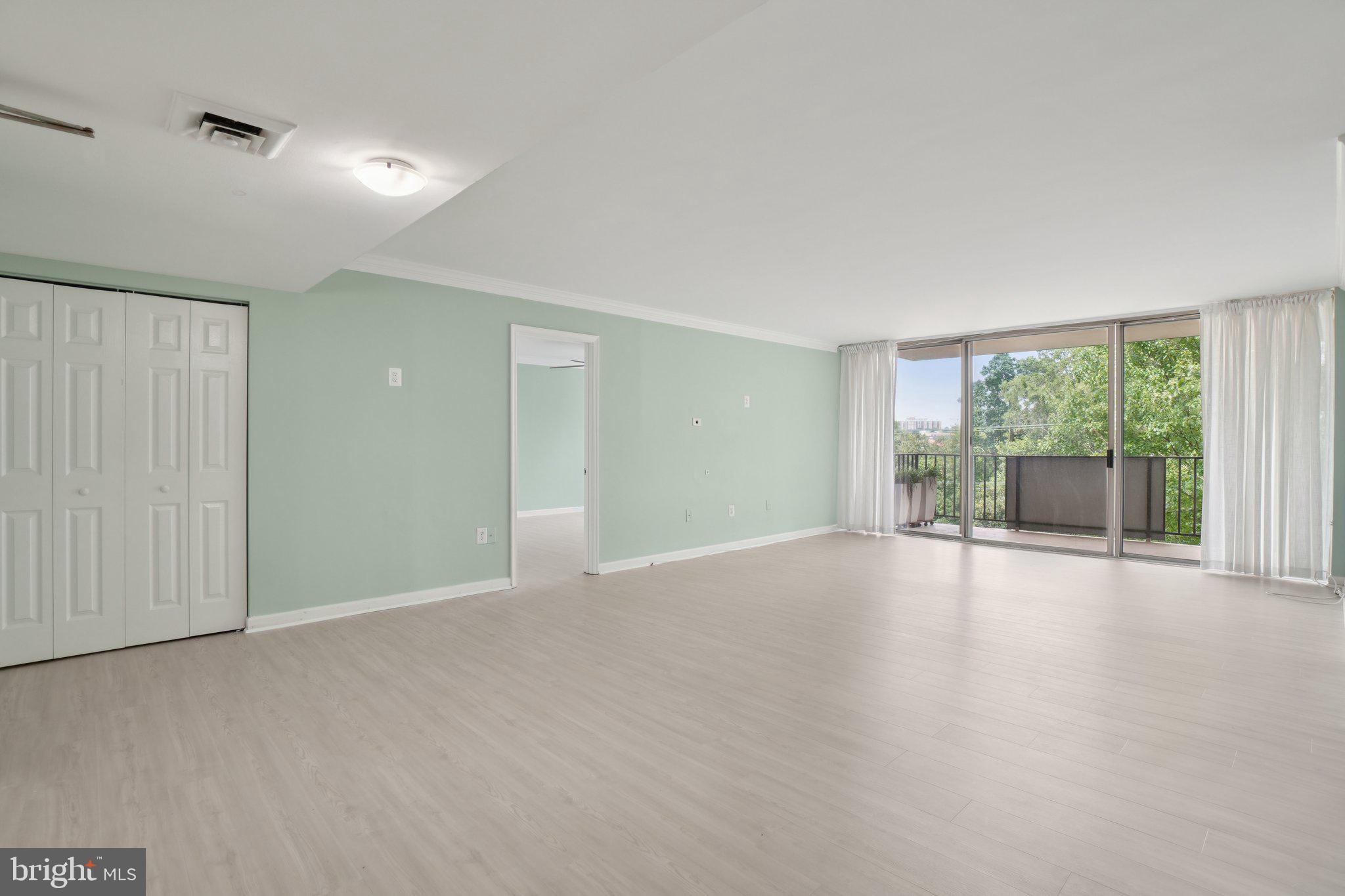 1515 South Arlington Ridge Road, Unit 603 Arlington, VA 22202 - Photo 3 of 39 a view of a big room with windows and chandelier fan