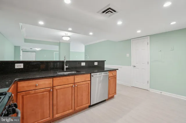 a bathroom with double vanity and a mirror
