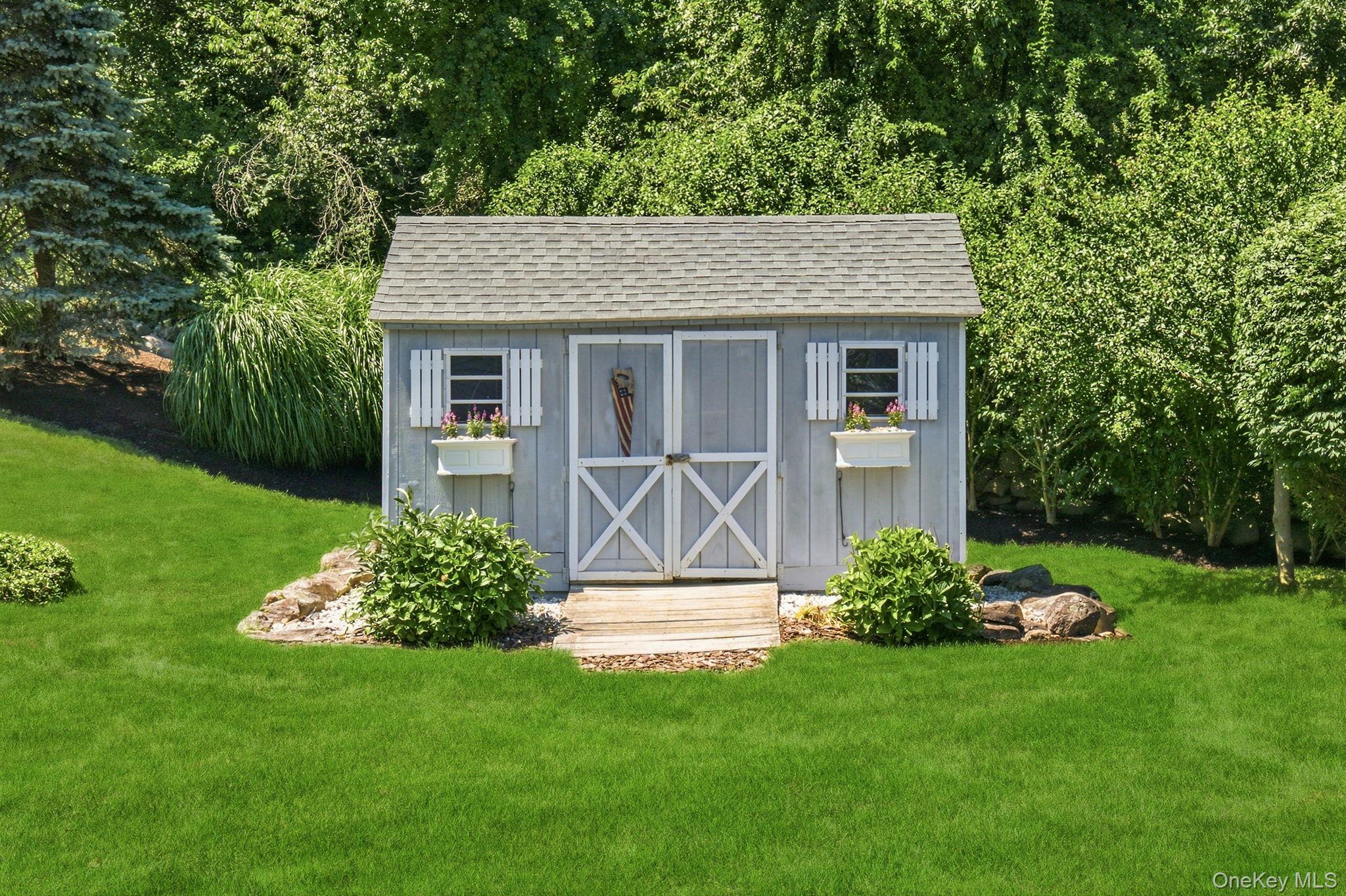 32 Bedell Road Katonah, NY 10536 - Photo 34 of 49 The charming storage shed features window boxes and double barn-style doors.