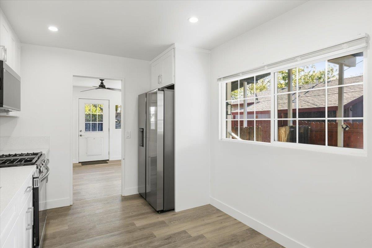 209 Dewitt Court Sacramento, CA 95838 - Photo 19 of 25 kitchen with white cabinetry, stainless steel appliances, light wood-style floors, recessed lighting, and a ceiling fan