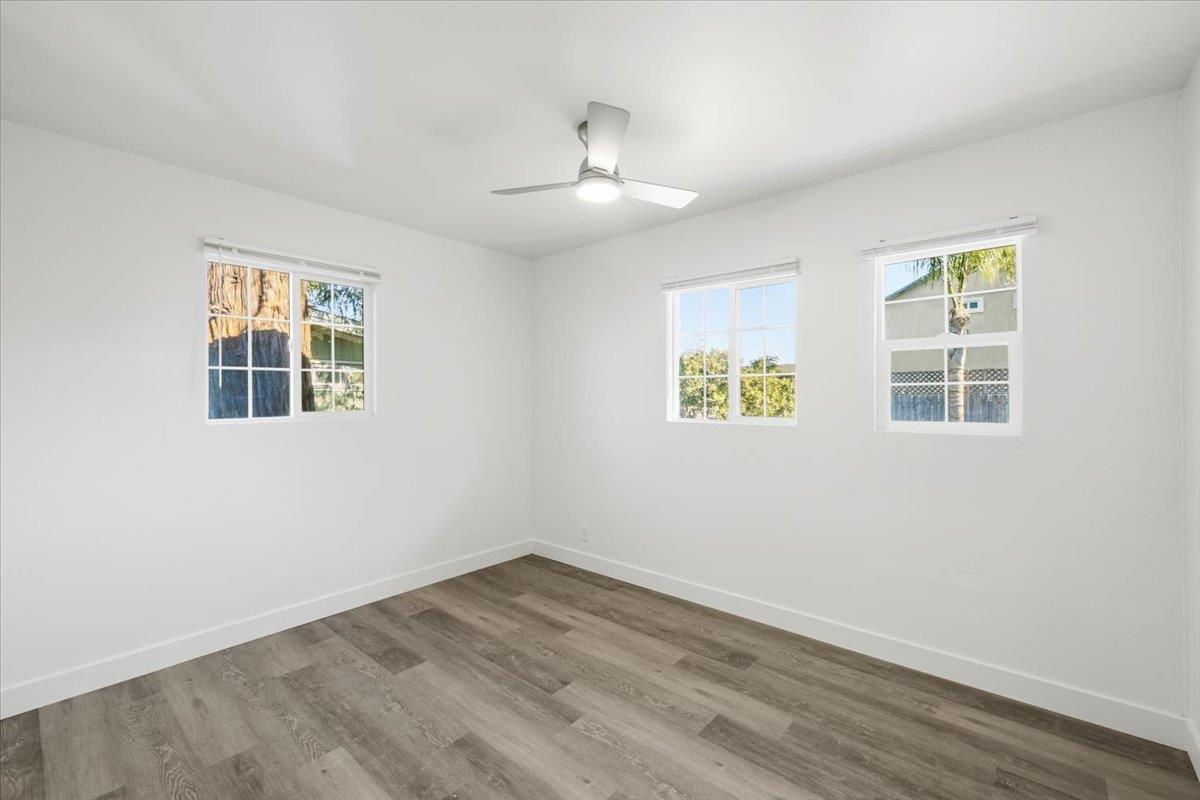 209 Dewitt Court Sacramento, CA 95838 - Photo 20 of 25 empty room with wood finished floors and ceiling fan