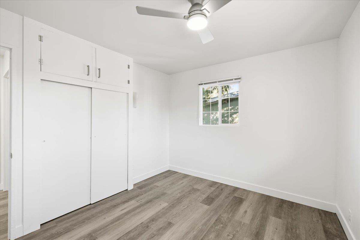 209 Dewitt Court Sacramento, CA 95838 - Photo 21 of 25 unfurnished bedroom with light wood-type flooring, a closet, and ceiling fan