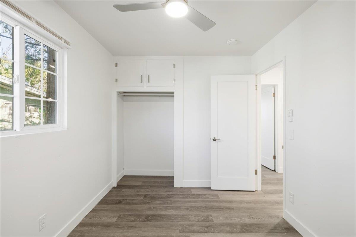 209 Dewitt Court Sacramento, CA 95838 - Photo 23 of 25 unfurnished bedroom featuring dark wood-style flooring, a closet, and a ceiling fan