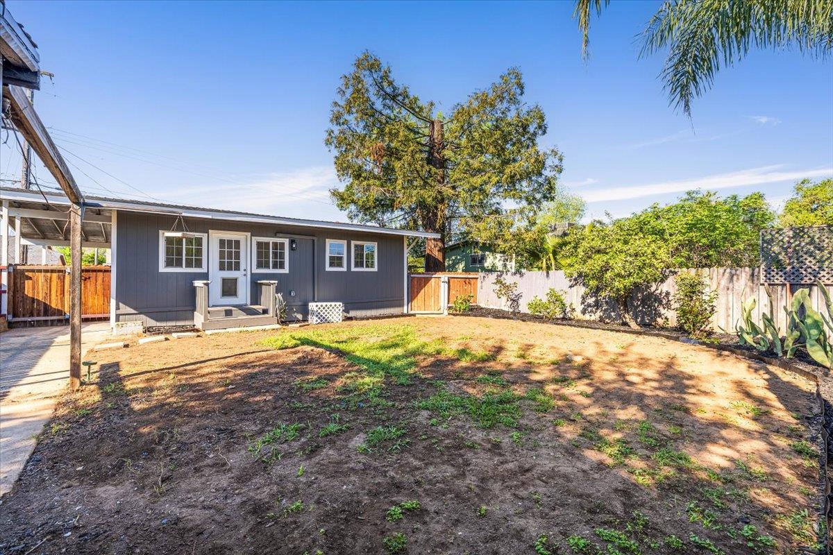 209 Dewitt Court Sacramento, CA 95838 - Photo 7 of 25 back of property featuring a fenced backyard and a gate and dog run on the other side