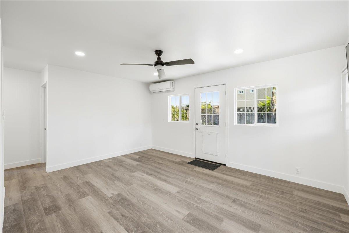 209 Dewitt Court Sacramento, CA 95838 - Photo 10 of 25 doorway to backyard, ceiling fan, recessed lighting, and light wood finished floors LVP