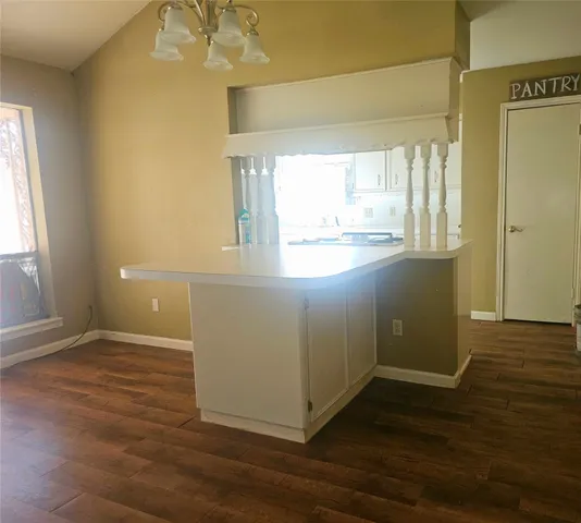 a kitchen with cabinets appliances a sink and a window