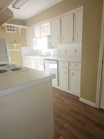 a view of a kitchen with wooden floor