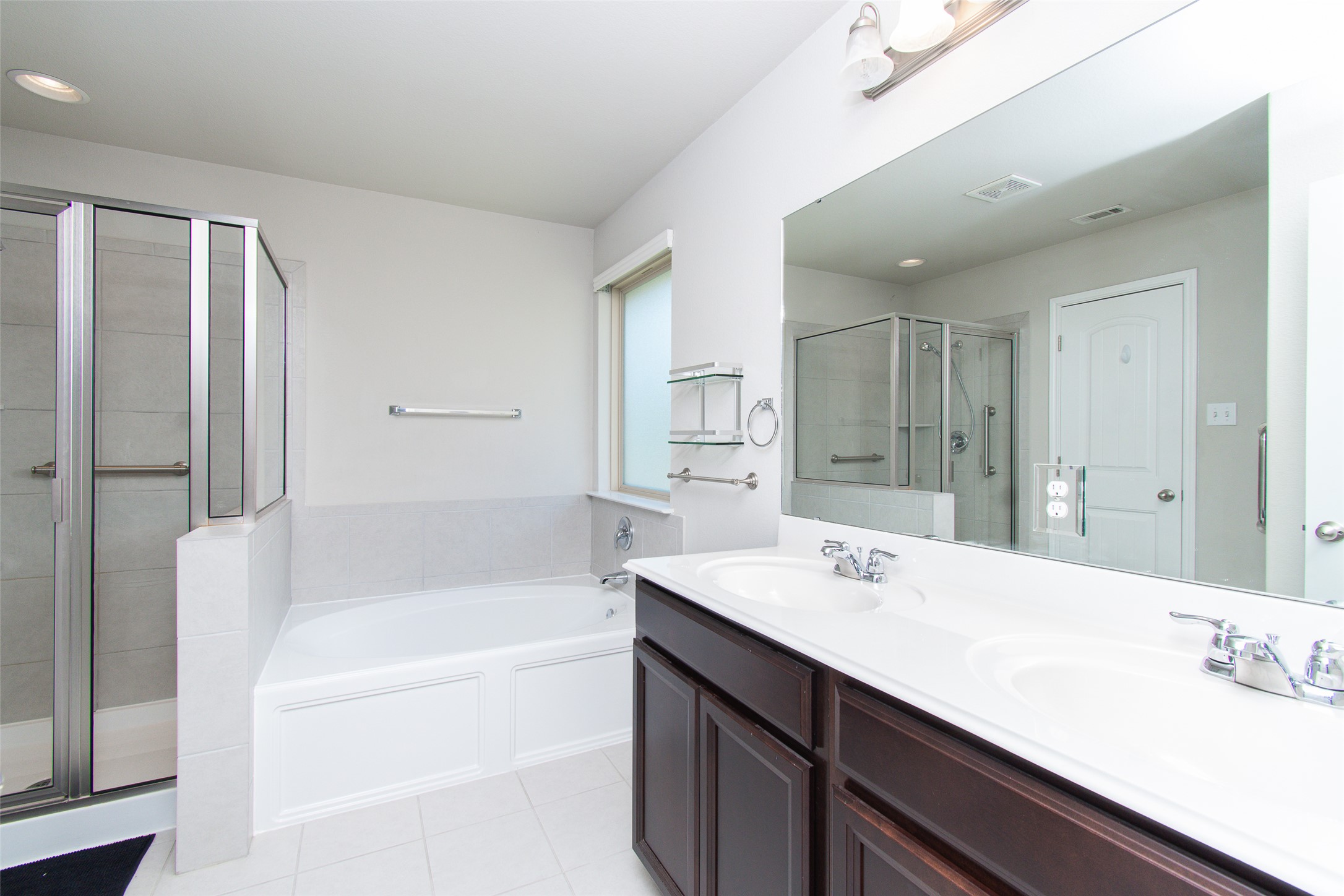 136 Mistflower Lane Kyle, TX 78640 - Photo 12 of 20 a bathroom with a tub sink double and mirror