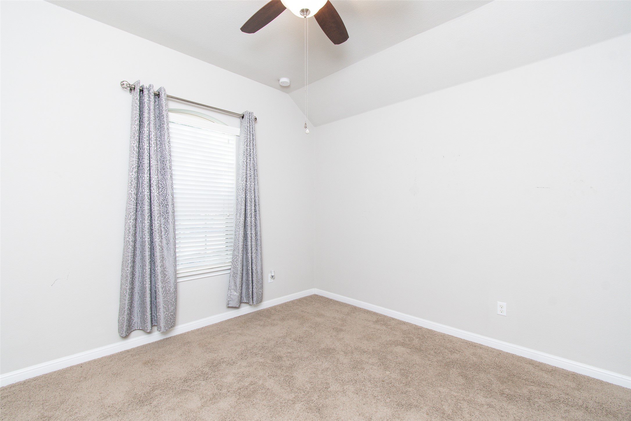 136 Mistflower Lane Kyle, TX 78640 - Photo 14 of 20 an empty room with ceiling fan and window