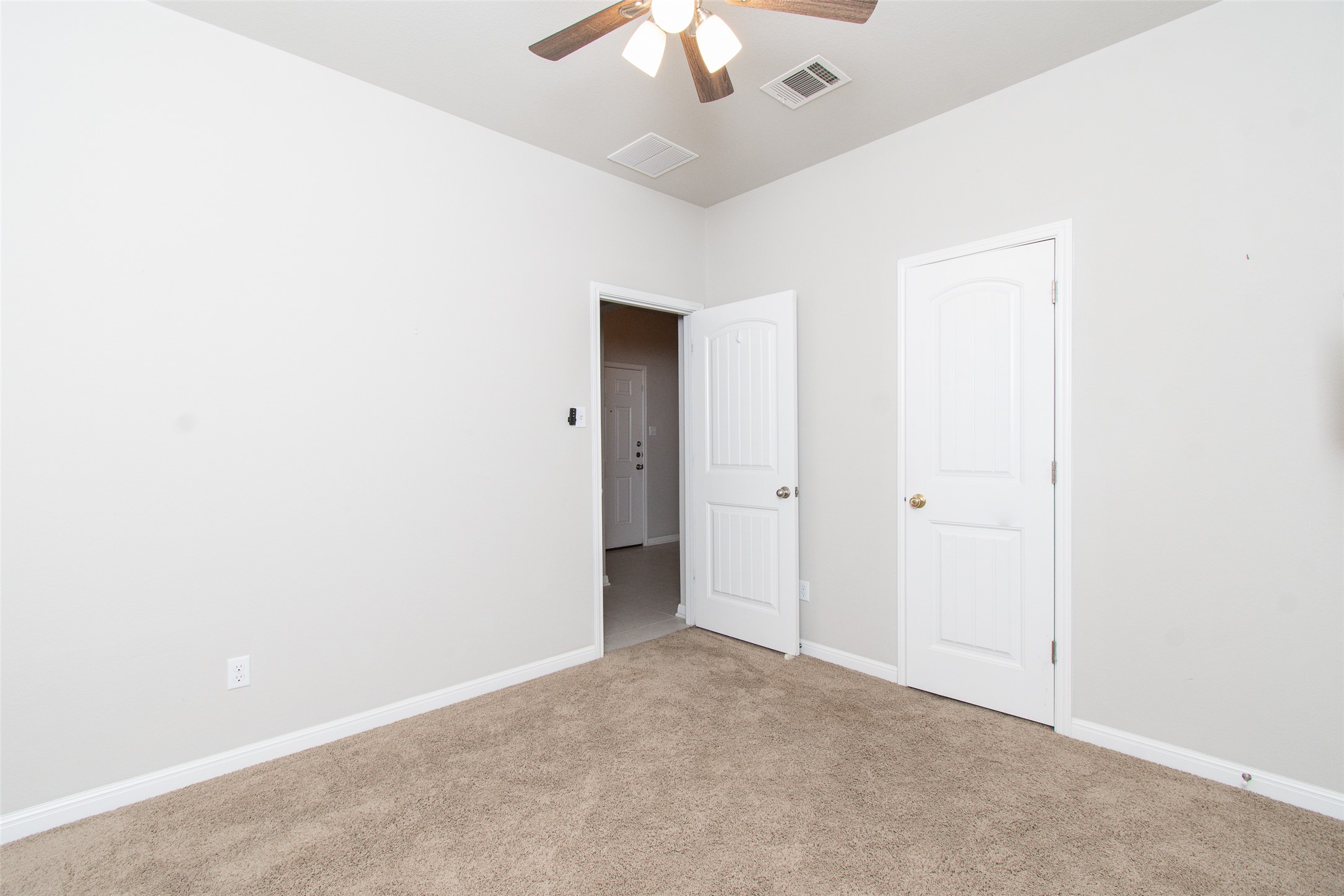136 Mistflower Lane Kyle, TX 78640 - Photo 17 of 20 an empty room with a ceiling fan and window