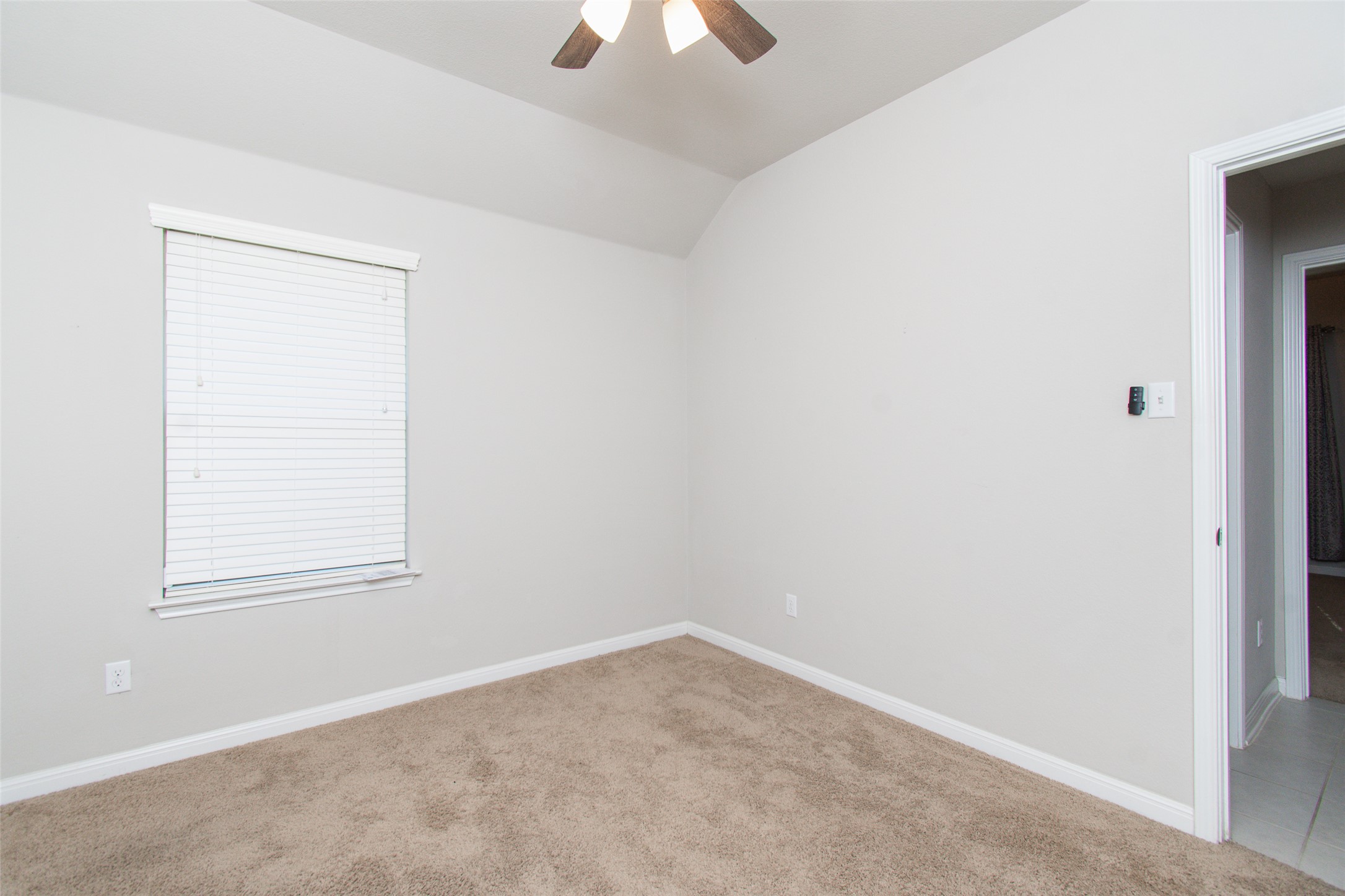 136 Mistflower Lane Kyle, TX 78640 - Photo 18 of 20 an empty room with a window and a chandelier fan