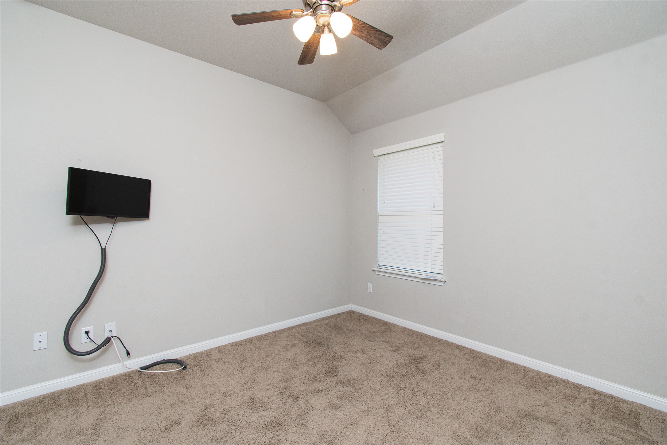 136 Mistflower Lane Kyle, TX 78640 - Photo 19 of 20 an empty room with ceiling fan and window