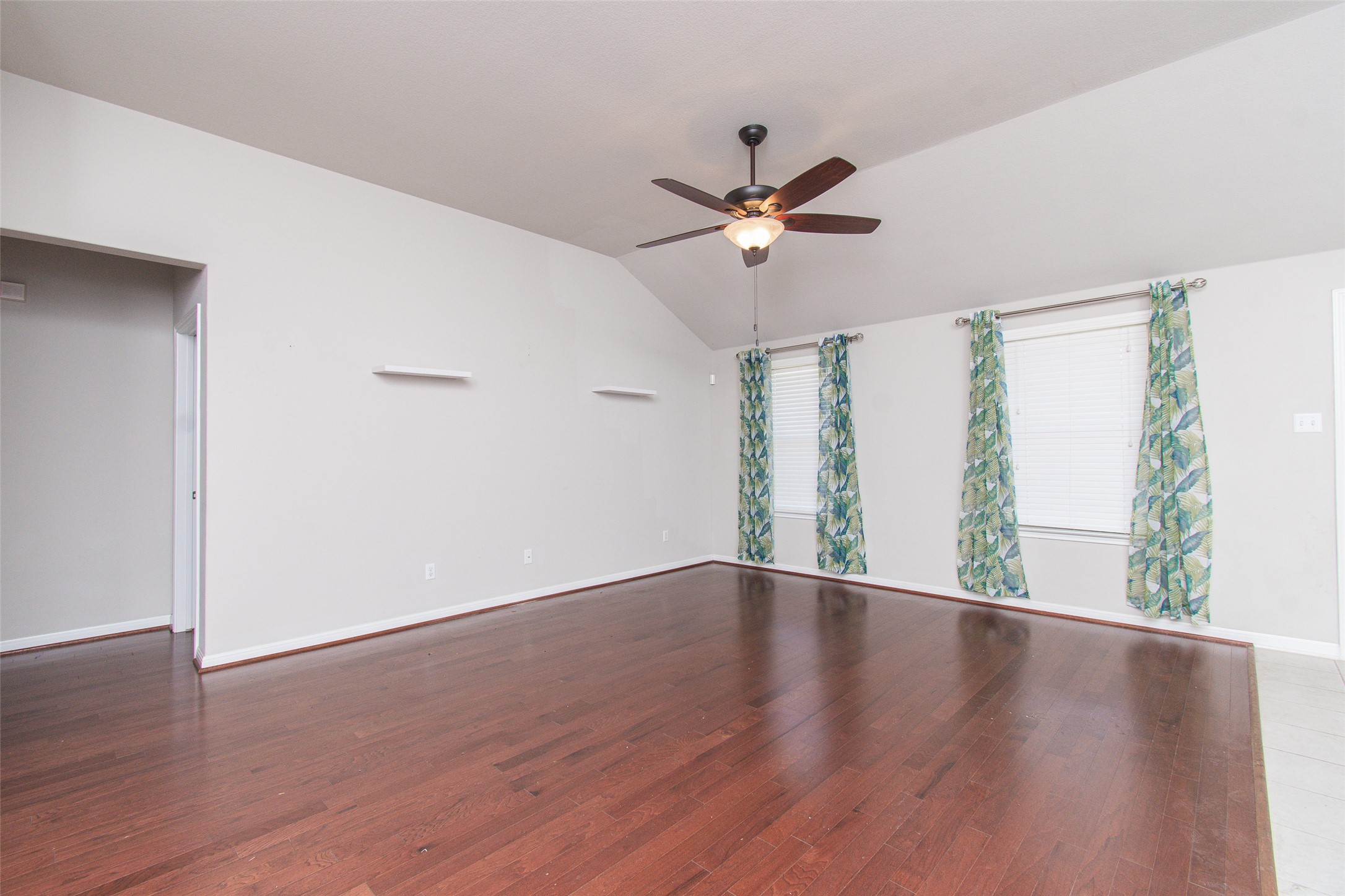 136 Mistflower Lane Kyle, TX 78640 - Photo 2 of 20 a view of an empty room with wooden floor and a window