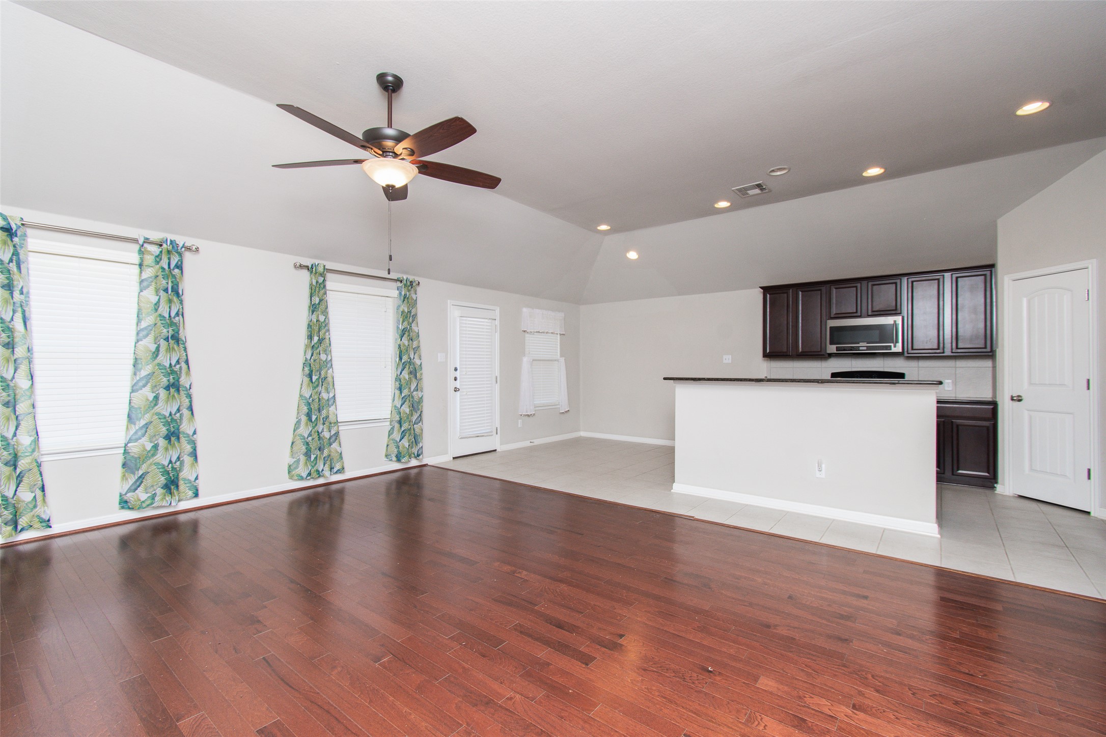 136 Mistflower Lane Kyle, TX 78640 - Photo 3 of 20 a view of a kitchen with a sink cabinets and wooden floor