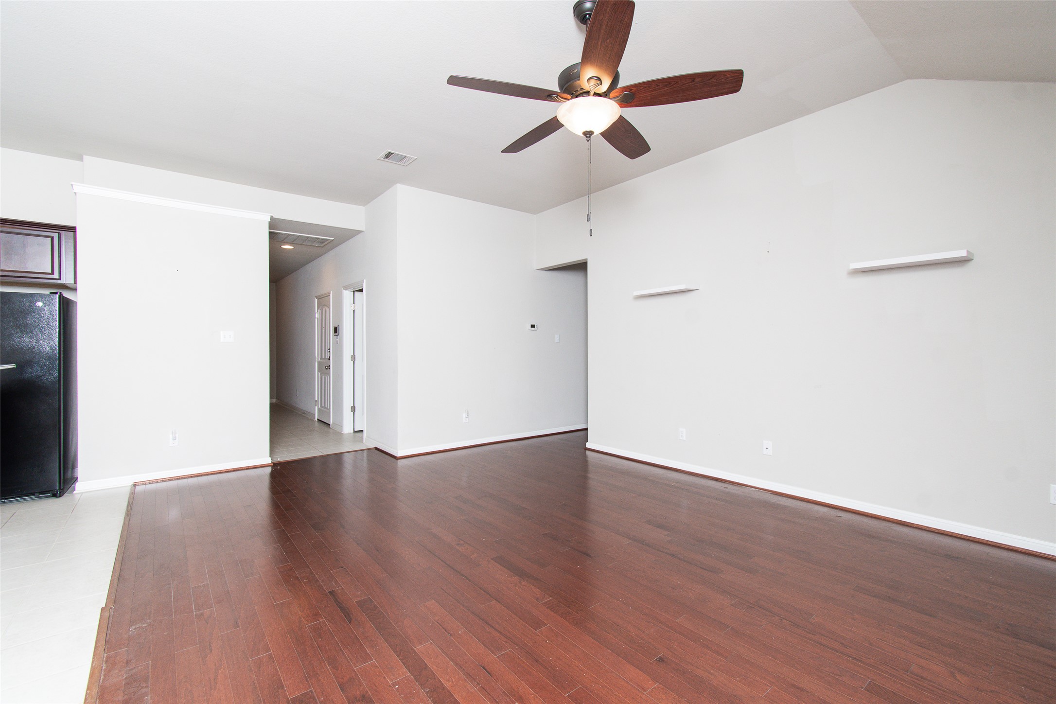 136 Mistflower Lane Kyle, TX 78640 - Photo 5 of 20 a view of an empty room with wooden floor