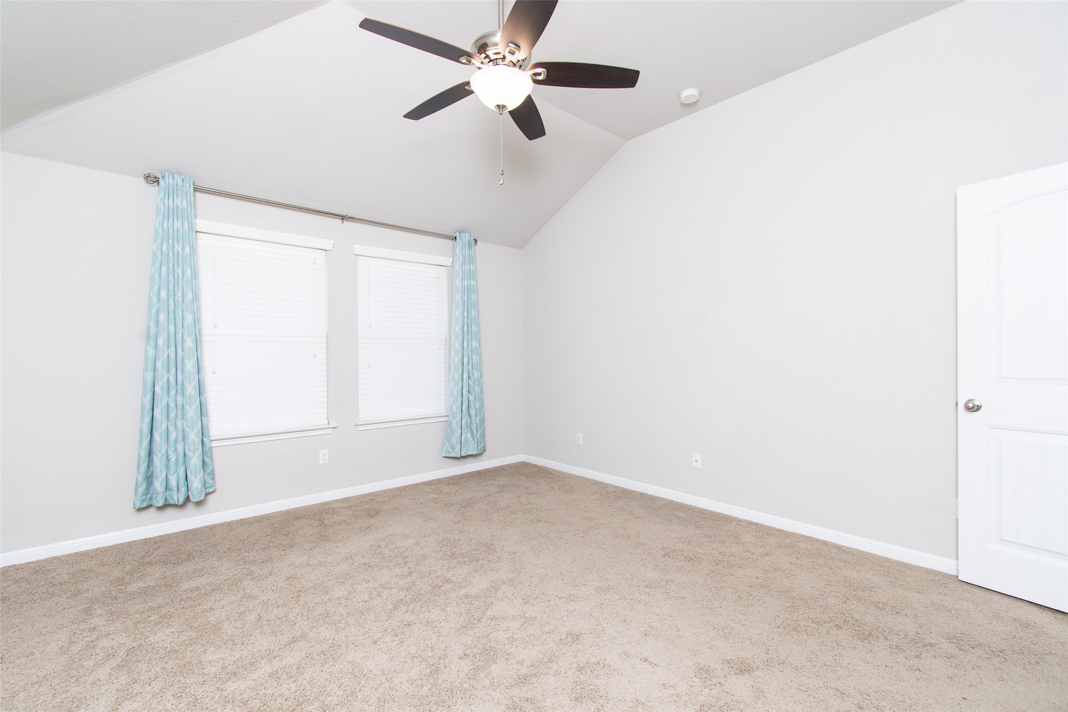 136 Mistflower Lane Kyle, TX 78640 - Photo 10 of 20 an empty room with windows and fan