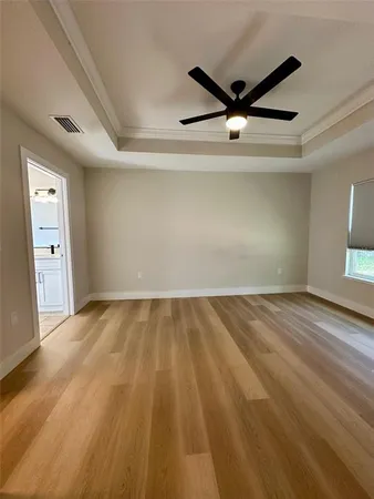 a view of a ceiling fan and wooden floor