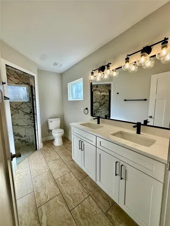 a spacious bathroom with a sink and mirror