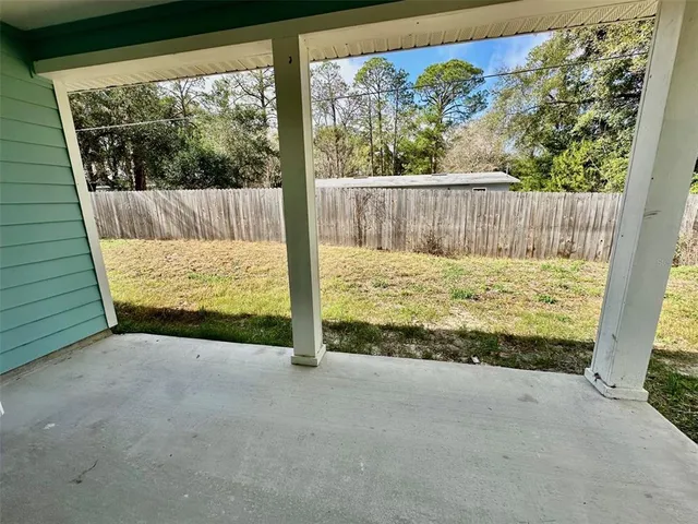 a view of room with wooden floor and a tub