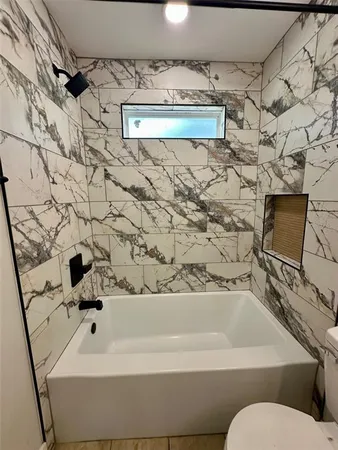 a bathroom with a bathtub and shower