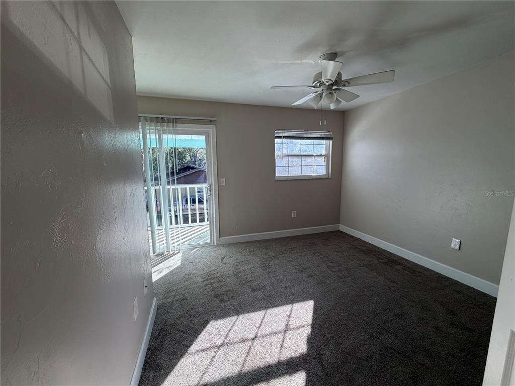 1718 Southwest 69th Terrace, Unit A Gainesville, FL 32607 - Photo 3 of 6 wooden floor in an empty room with a window