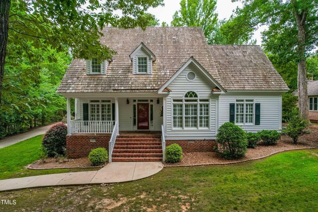 a front view of a house with a yard and porch