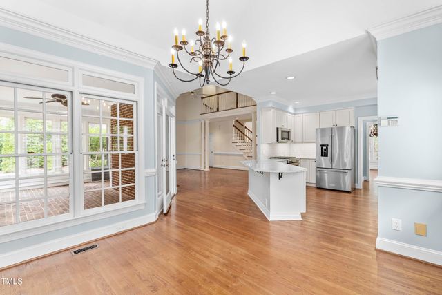 a view of a kitchen with furniture and wooden floor