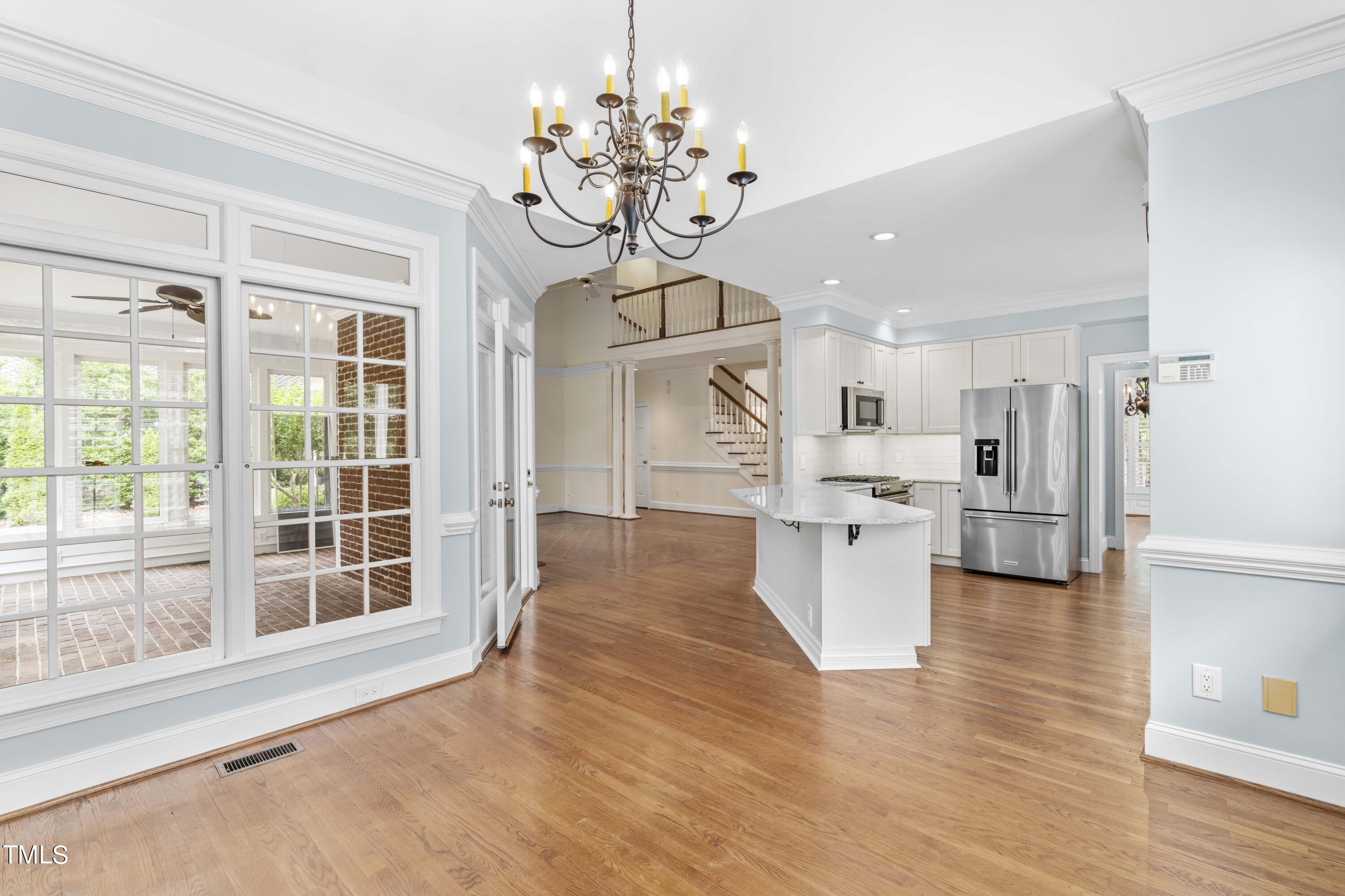 1556 Crenshaw Point Wake Forest, NC 27587 - Photo 16 of 46 a view of a kitchen with furniture and wooden floor