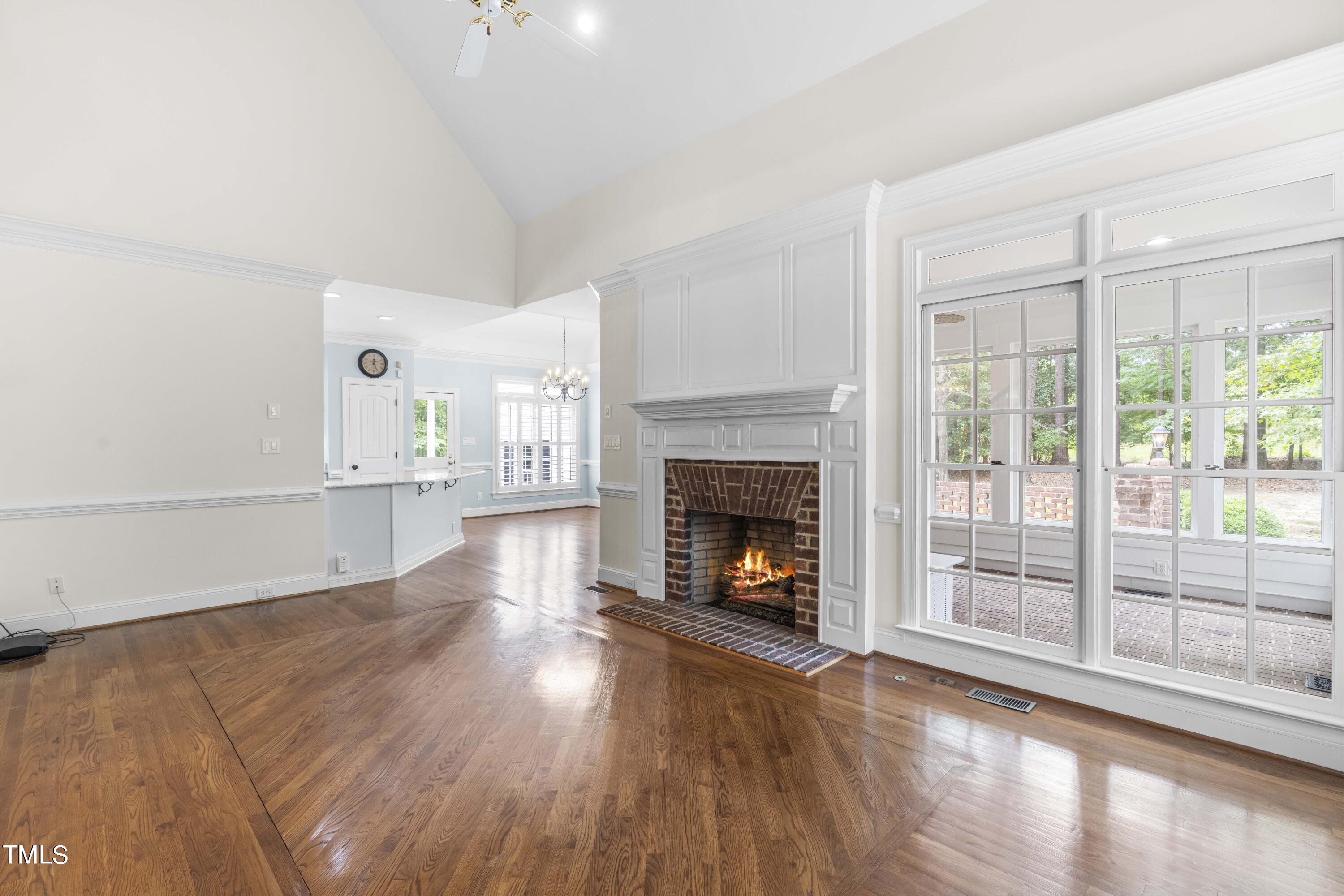 1556 Crenshaw Point Wake Forest, NC 27587 - Photo 19 of 46 a view of an empty room with wooden floor fire place and windows
