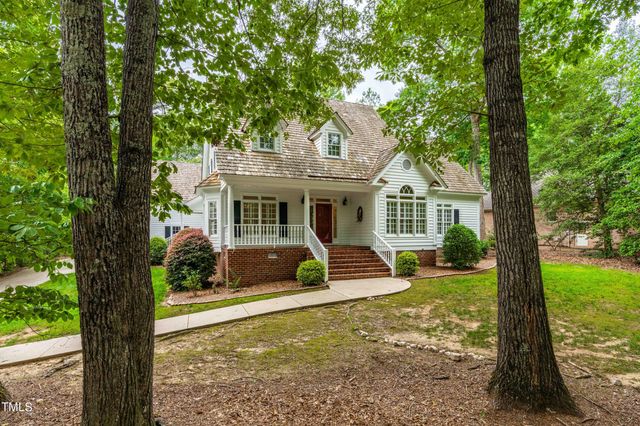 a view of a house with backyard sitting area and garden