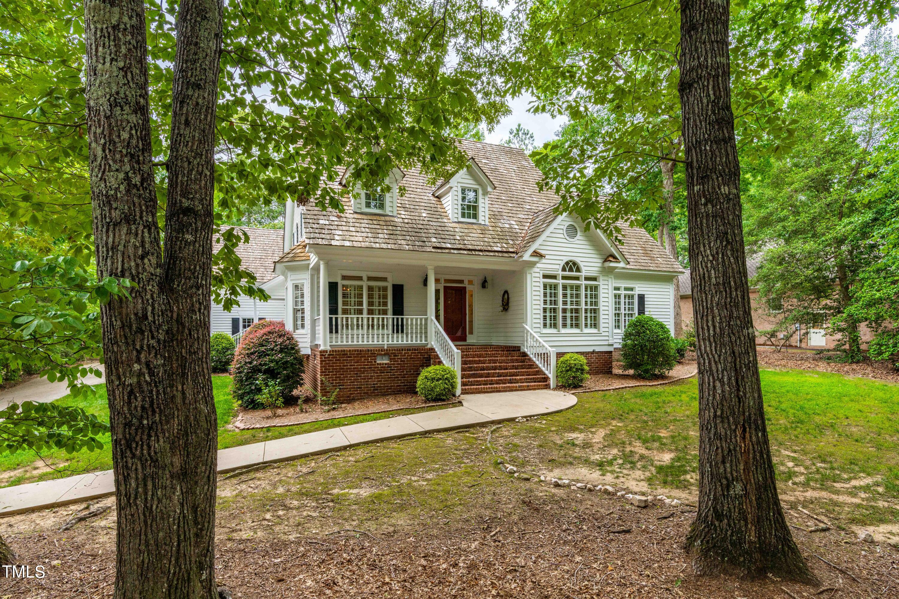 1556 Crenshaw Point Wake Forest, NC 27587 - Photo 2 of 46 a view of a house with backyard sitting area and garden