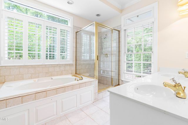 a spacious bathroom with sink shower and bathtub