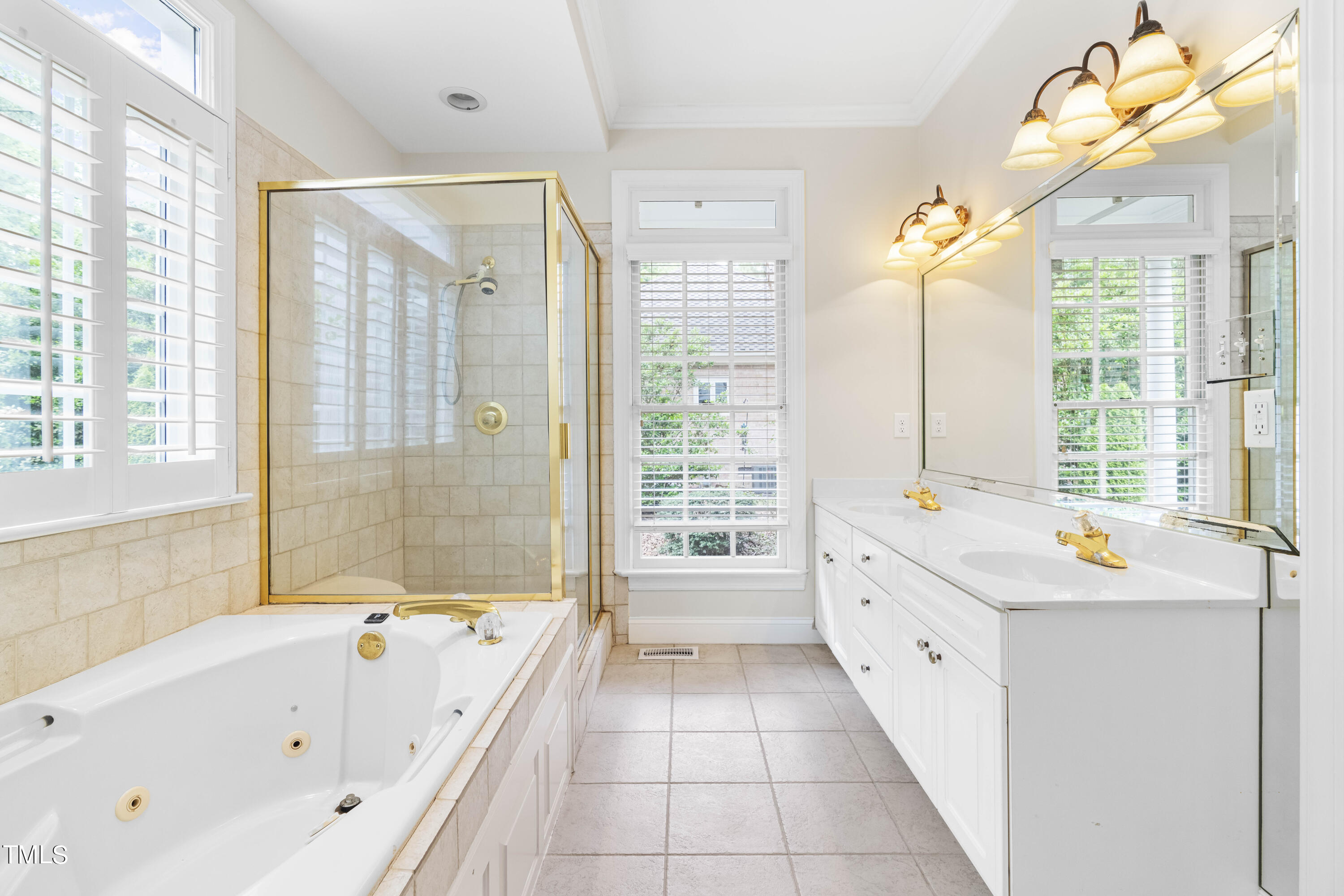 1556 Crenshaw Point Wake Forest, NC 27587 - Photo 25 of 46 a bathroom with a bathtub a double vanity and windows