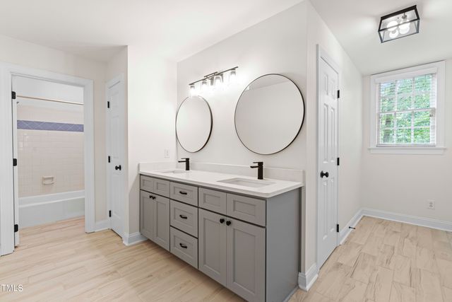 a bathroom with 2 sink and a mirror