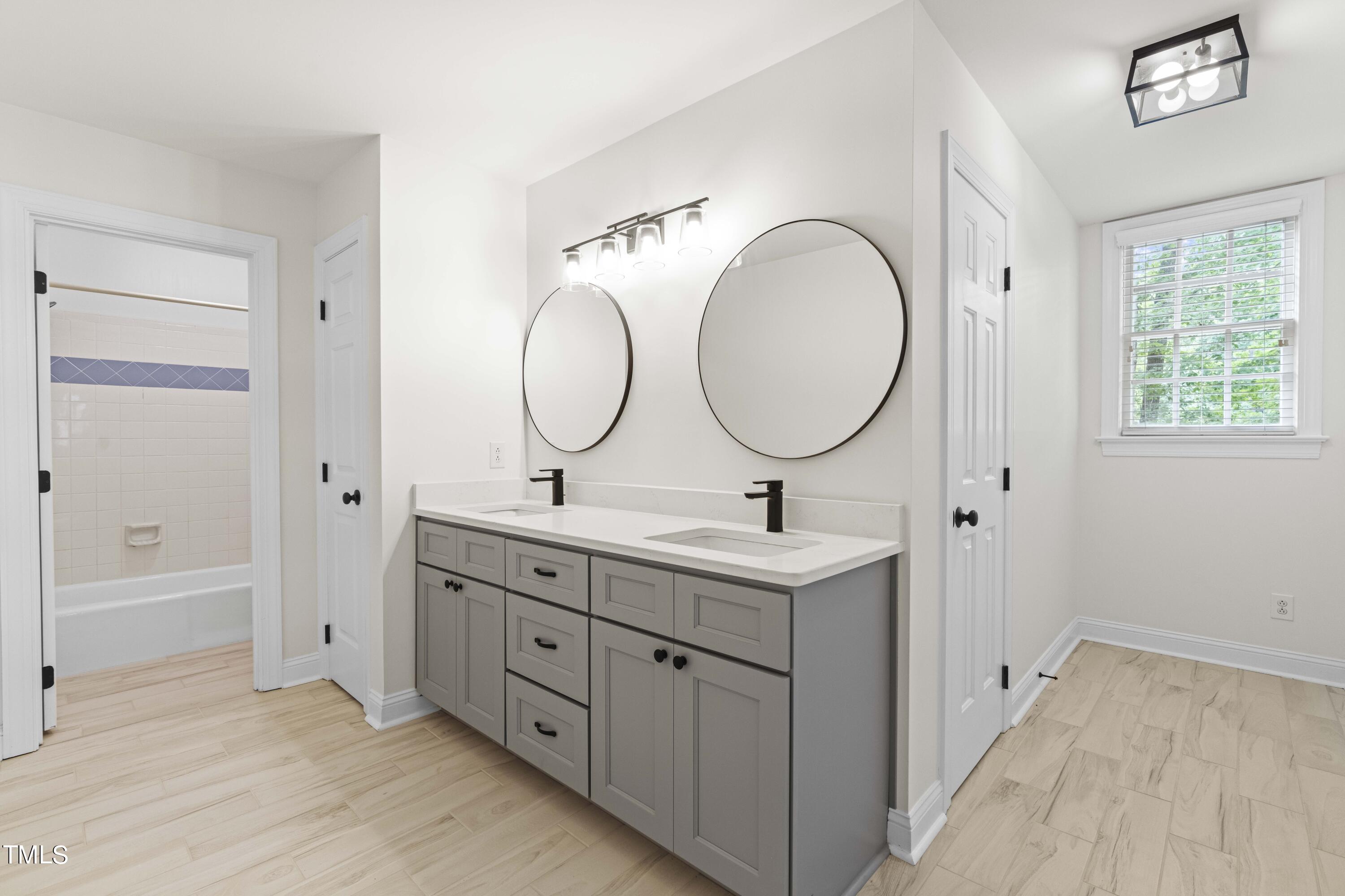 1556 Crenshaw Point Wake Forest, NC 27587 - Photo 36 of 46 a bathroom with 2 sink and a mirror