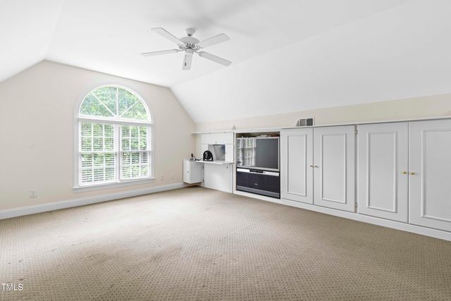 an empty room with furniture and a window