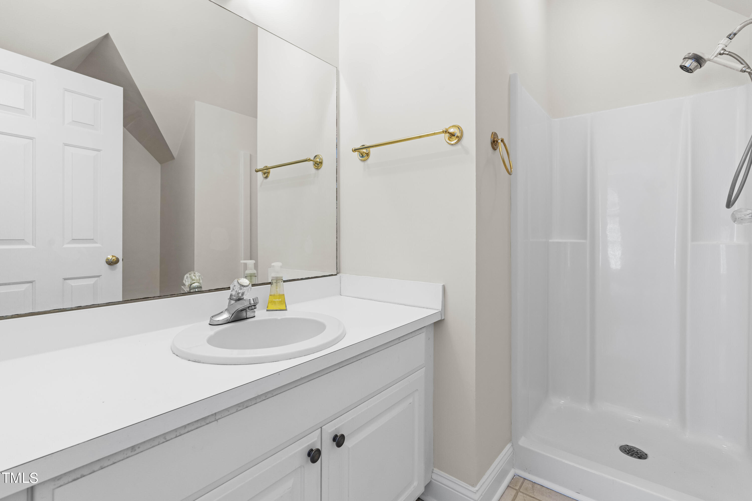1556 Crenshaw Point Wake Forest, NC 27587 - Photo 38 of 46 a bathroom with a sink and a mirror