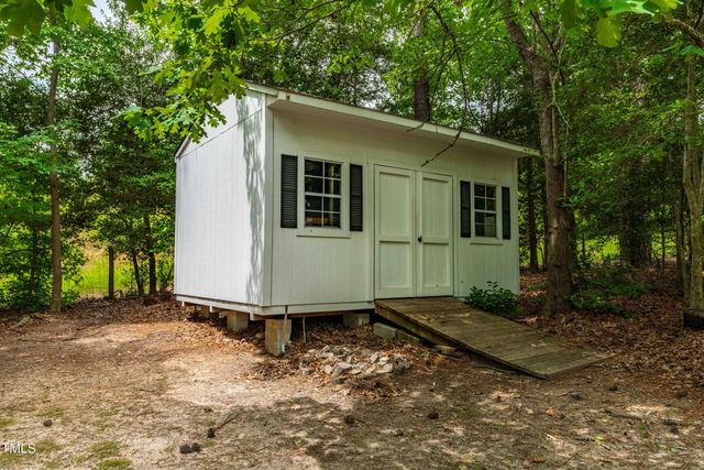 a view of a small house with a yard