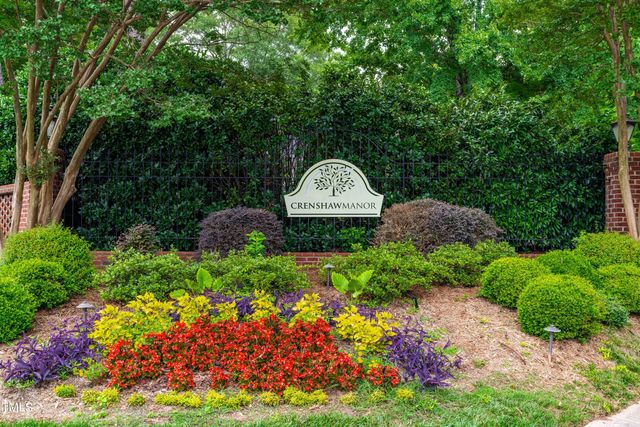a front view of a house with a yard and fountain