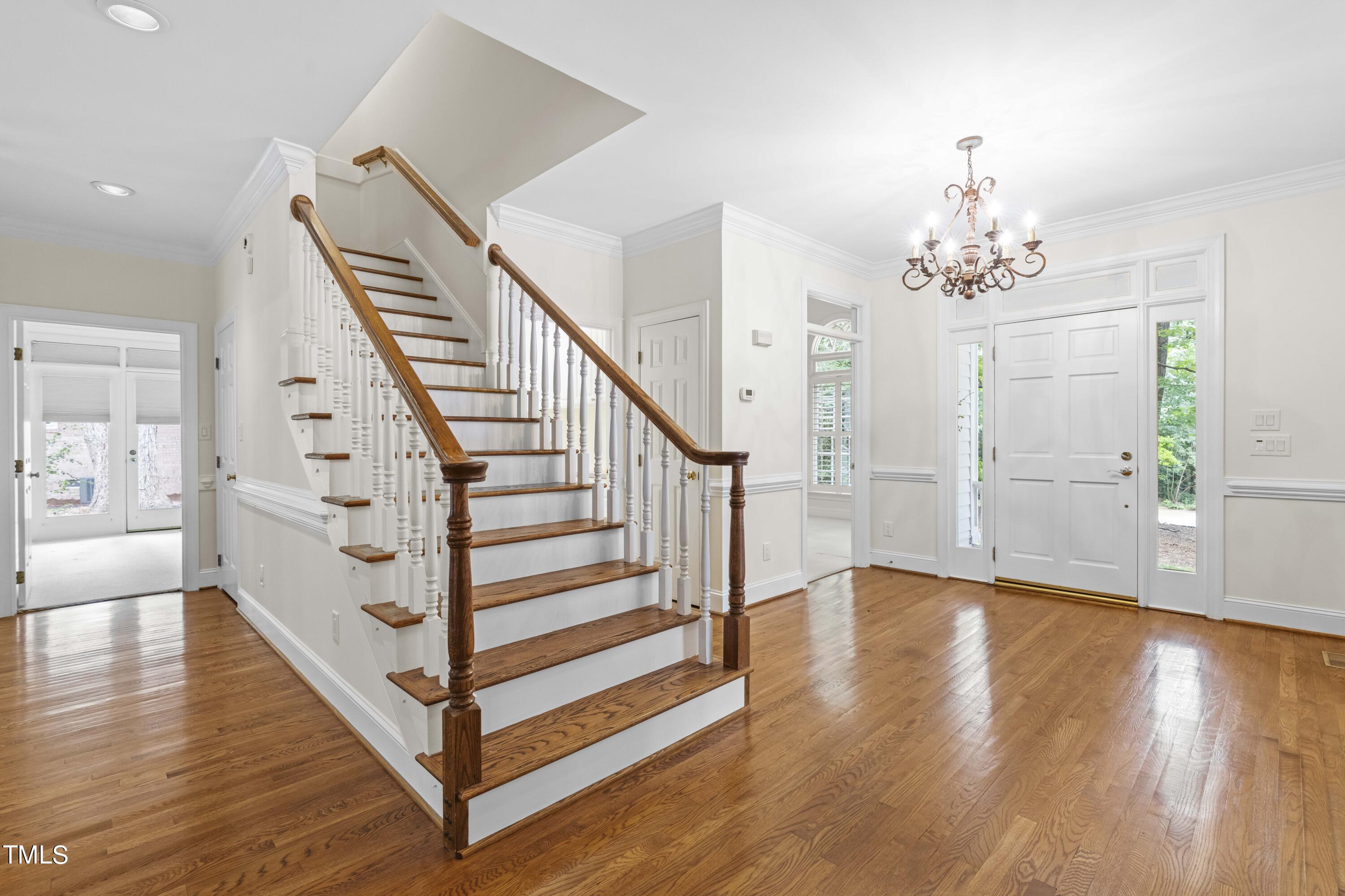 1556 Crenshaw Point Wake Forest, NC 27587 - Photo 6 of 46 a view of a hallway with stairs and wooden floor
