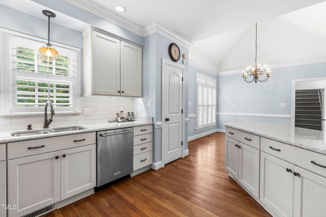a view of granite countertop cabinets with wooden floor