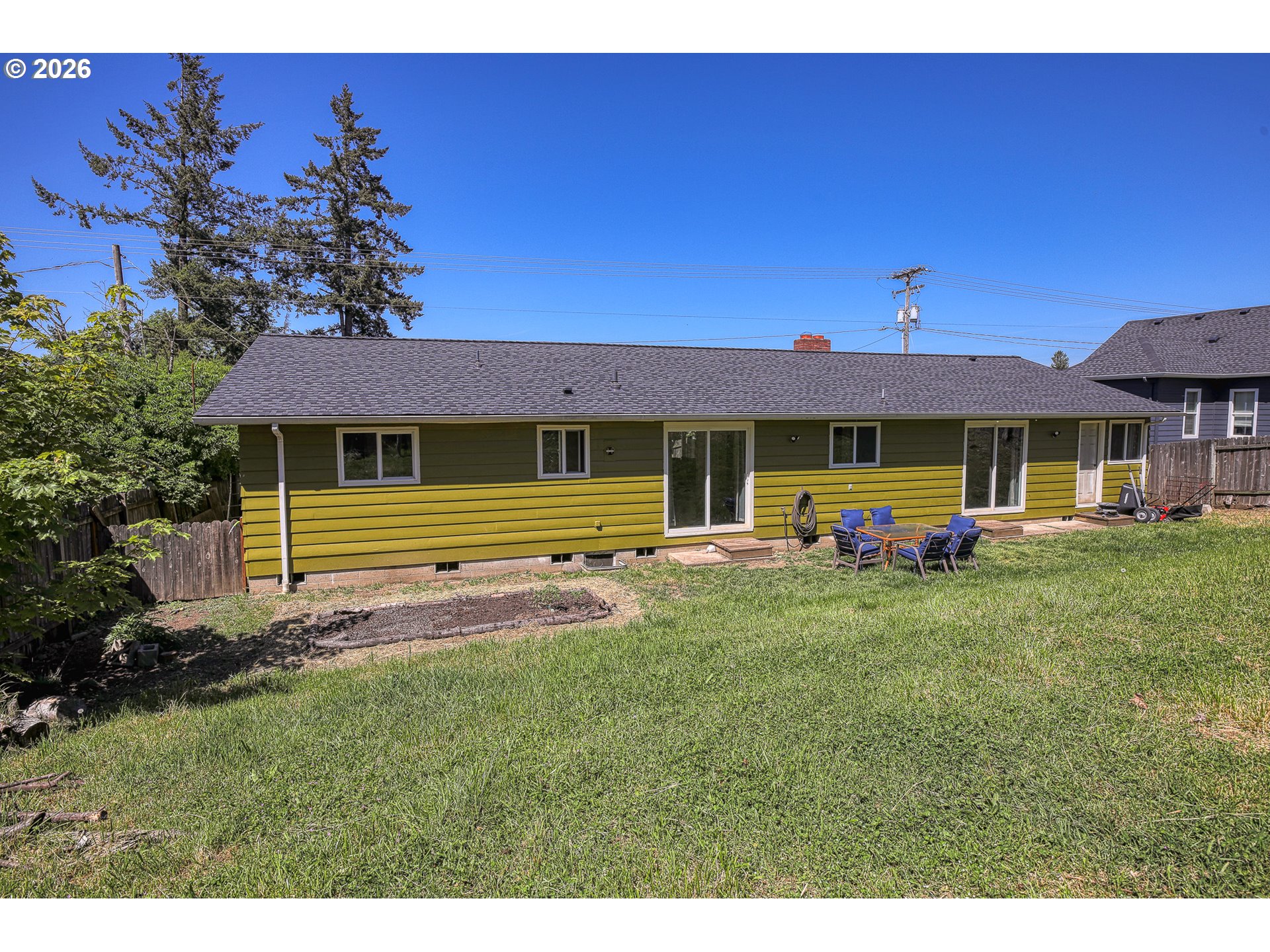 7077 Main Street Springfield, OR 97478 - Photo 31 of 34 a front view of a house with a garden