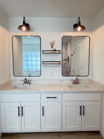 a spacious bathroom with a double vanity sink and mirror