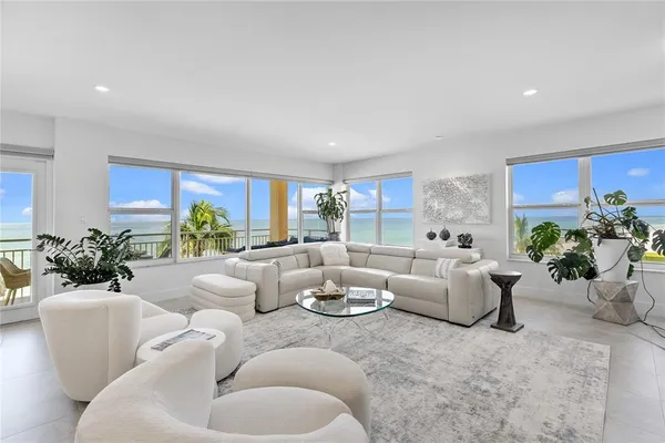 a living room with furniture potted plant and a window