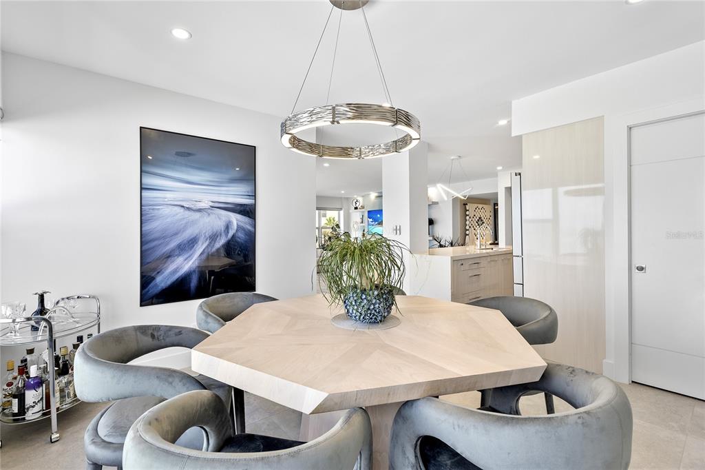601 Longboat Club Road, Unit 404S Longboat Key, FL 34228 - Photo 12 of 28 a view of a dining room with furniture and chandelier