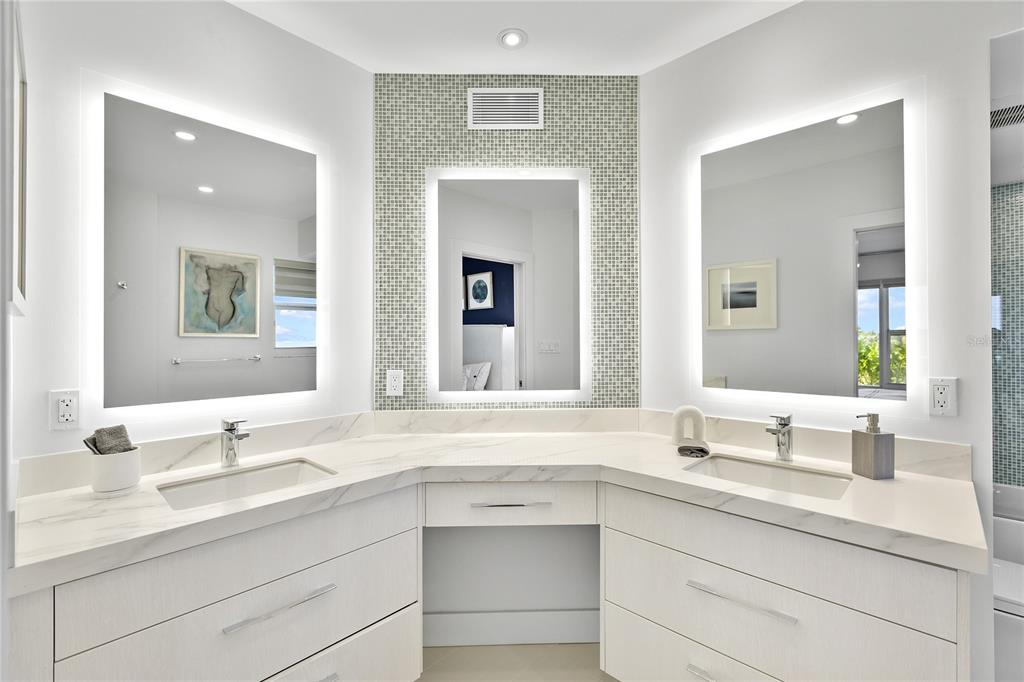 601 Longboat Club Road, Unit 404S Longboat Key, FL 34228 - Photo 19 of 28 a bathroom with double vanity sink a vanity and a mirror