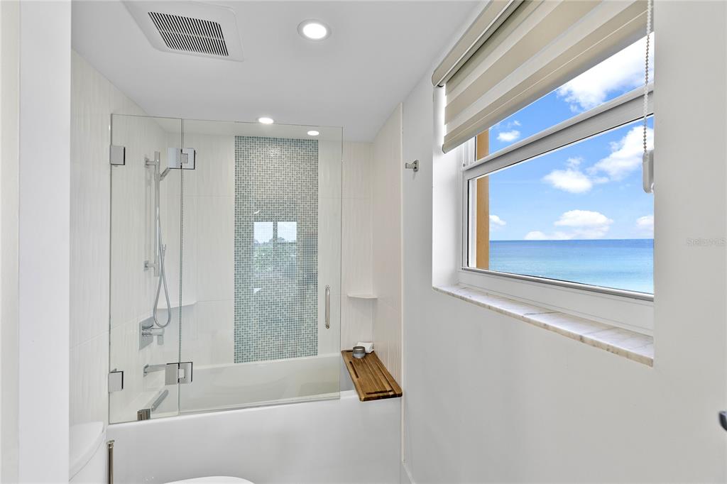 601 Longboat Club Road, Unit 404S Longboat Key, FL 34228 - Photo 20 of 28 a bathroom with a tub and a shower