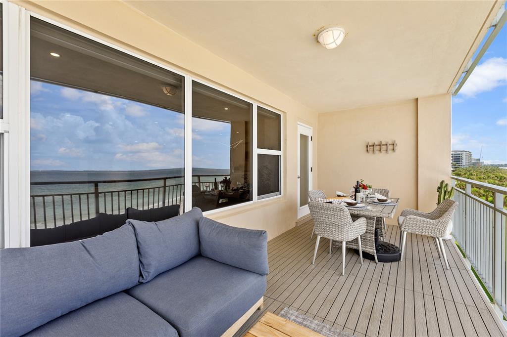 601 Longboat Club Road, Unit 404S Longboat Key, FL 34228 - Photo 28 of 28 a balcony with furniture and wooden floor
